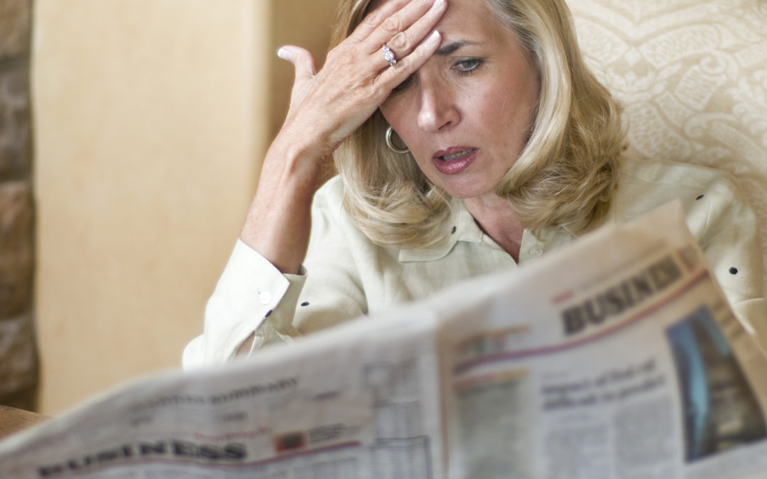 Nervous investor reads newspaper