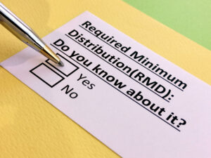 Checklist for Required Minimum Distributions, with notepad and pen